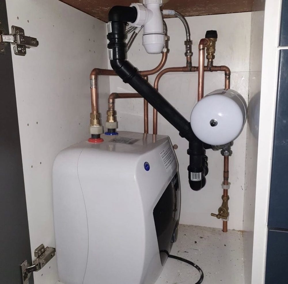 Under-sink water heater and drain plumbing in a Brampton home